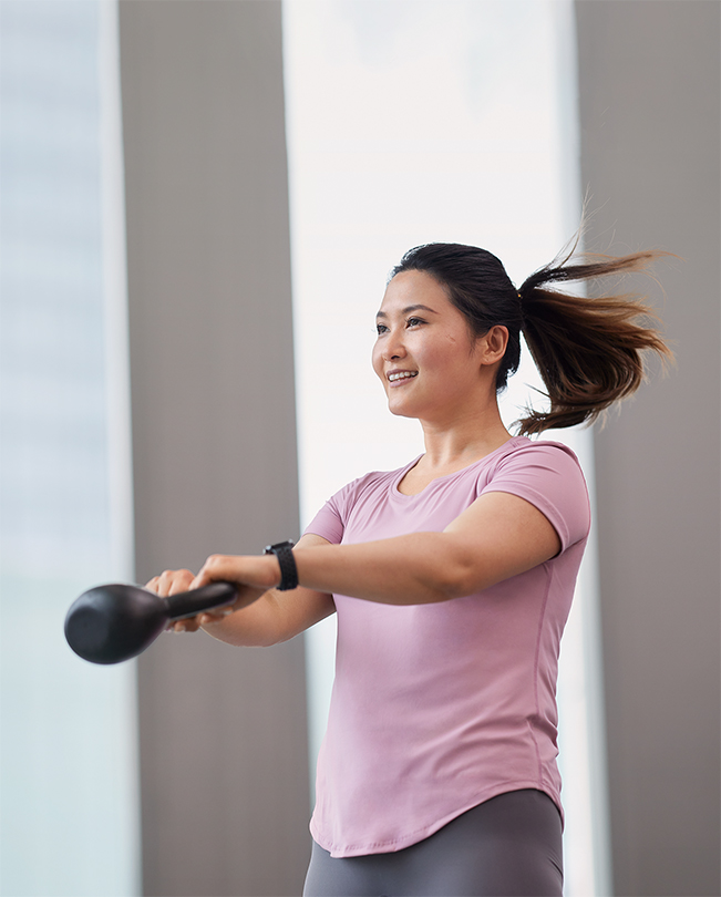 Uma funcionária da Apple a meio de um movimento com um kettlebell.