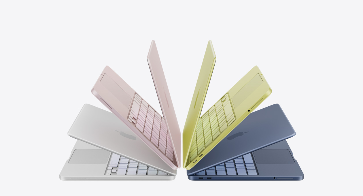 MacBook Neo Laptops in den Farben Silber, Rosa, Zitrus und Indigo, halb geöffnet und in einem Bogen angeordnet
